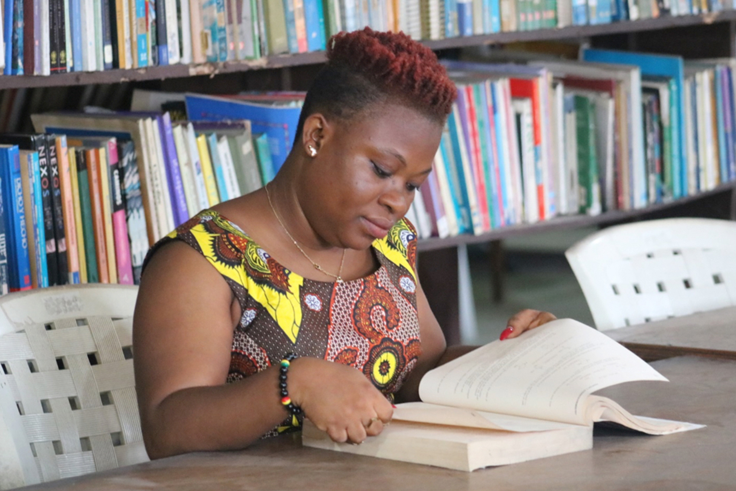 Edwina C. Togba, 39, studies. She is a student at the United Methodist University of Liberia, which she attends with support from a scholarship from United Women in Faith.  