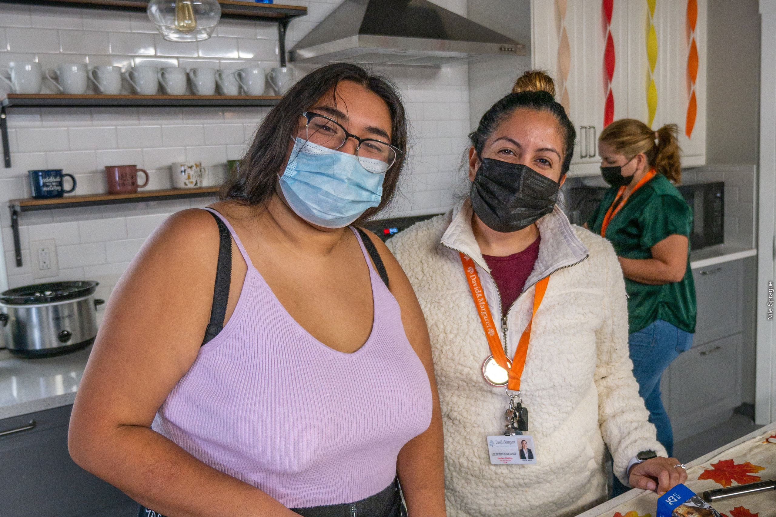 Cecilia Flores prepares a meal with Marilyn Medina in the student kitchen and lounge at David and Margaret Youth and Family Services in La Verne, California.