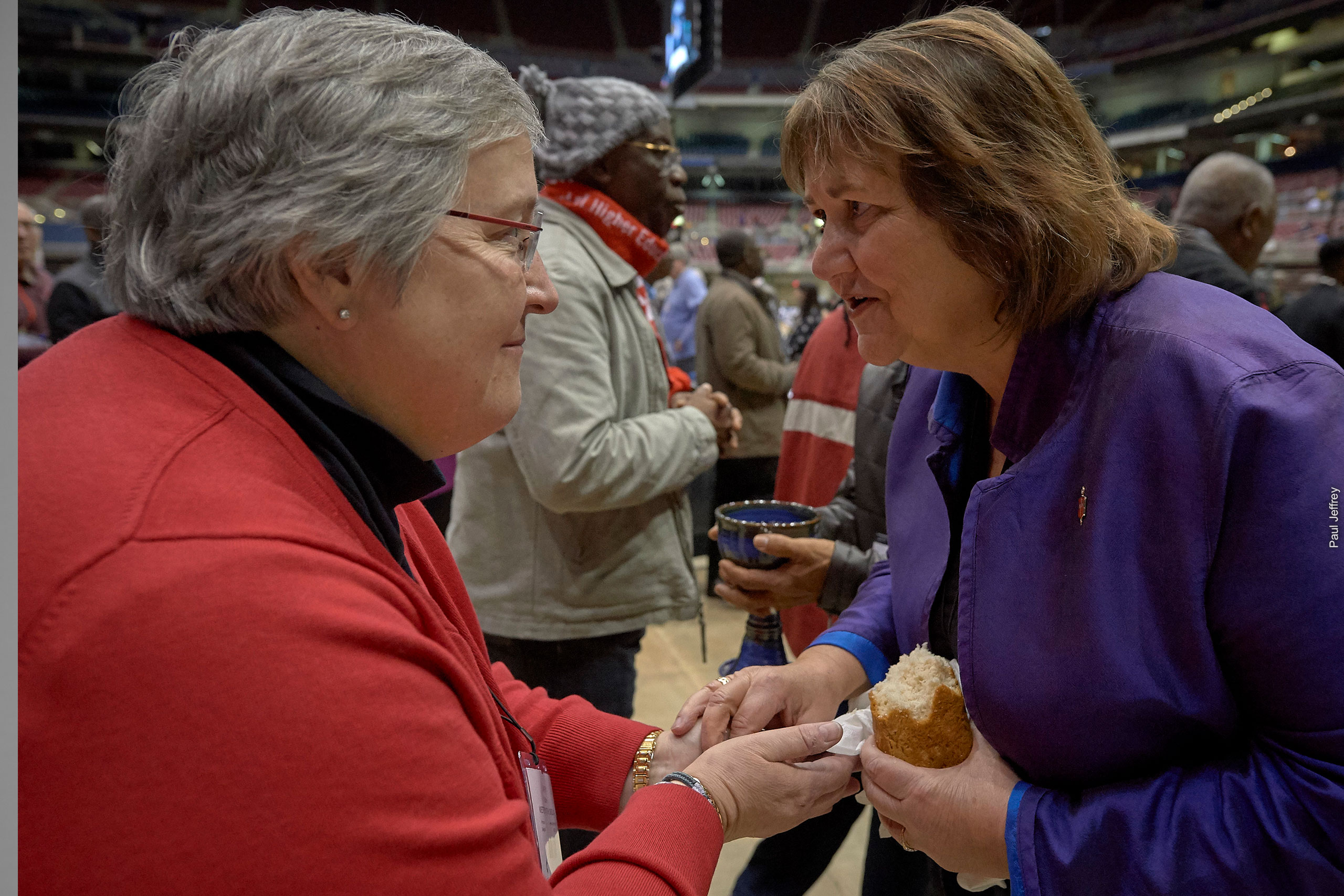 United Women in Faith member Lynne Gilbert receives communion from Bishop Karen Oliveto at the United Methodist General Conference 2019.