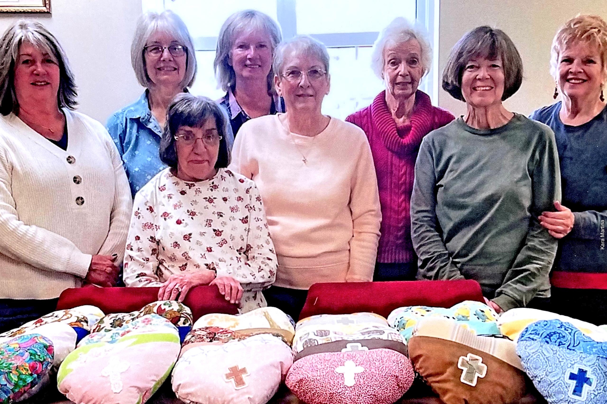 Members of the Dahlonega United Methodist Sewing Hearts Circle display their sewn pillows