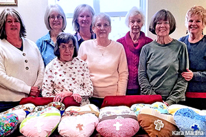 Members of the Dahlonega United Methodist Sewing Hearts Circle display their sewn pillows.