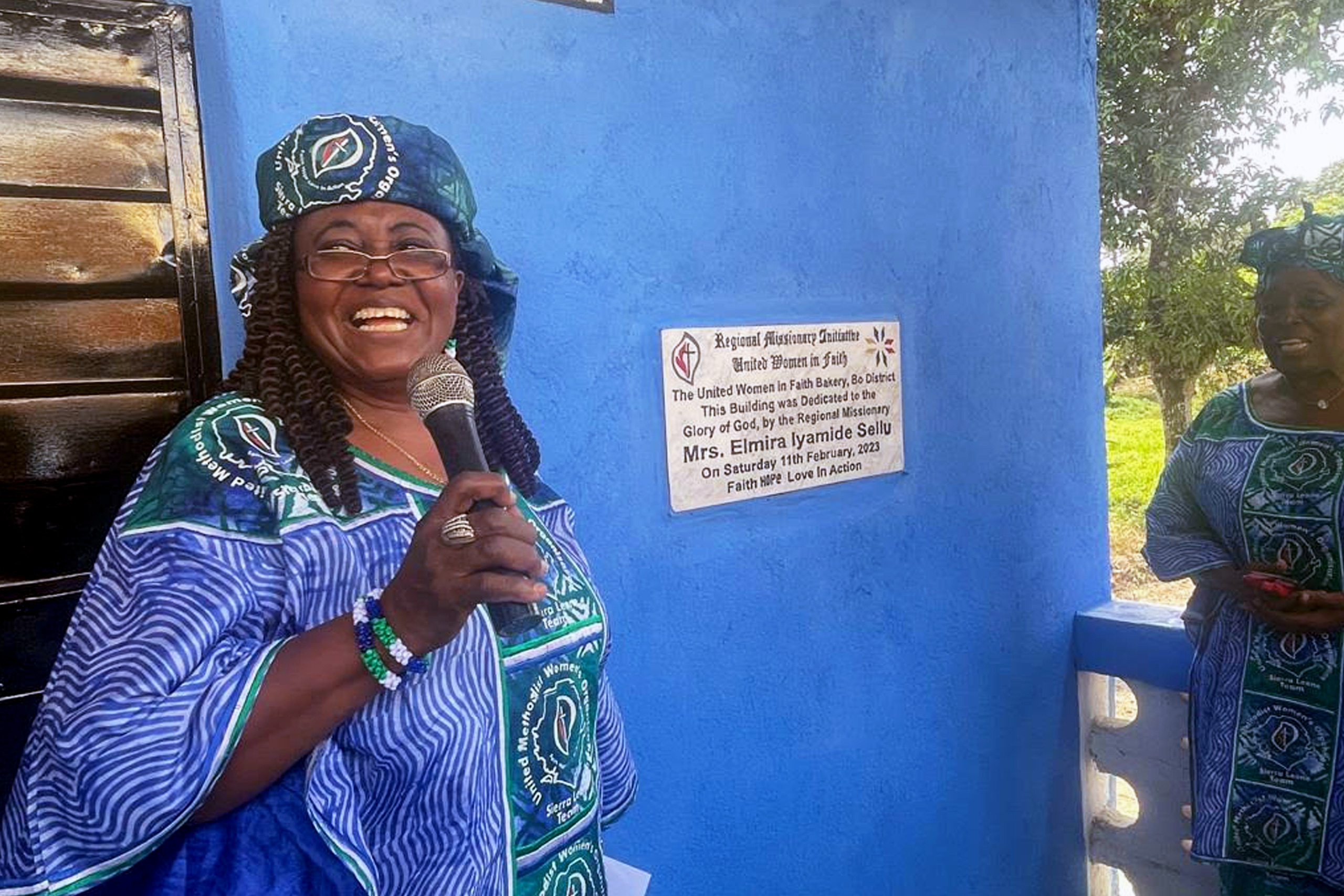 Elmira Sellu in front of the bakery