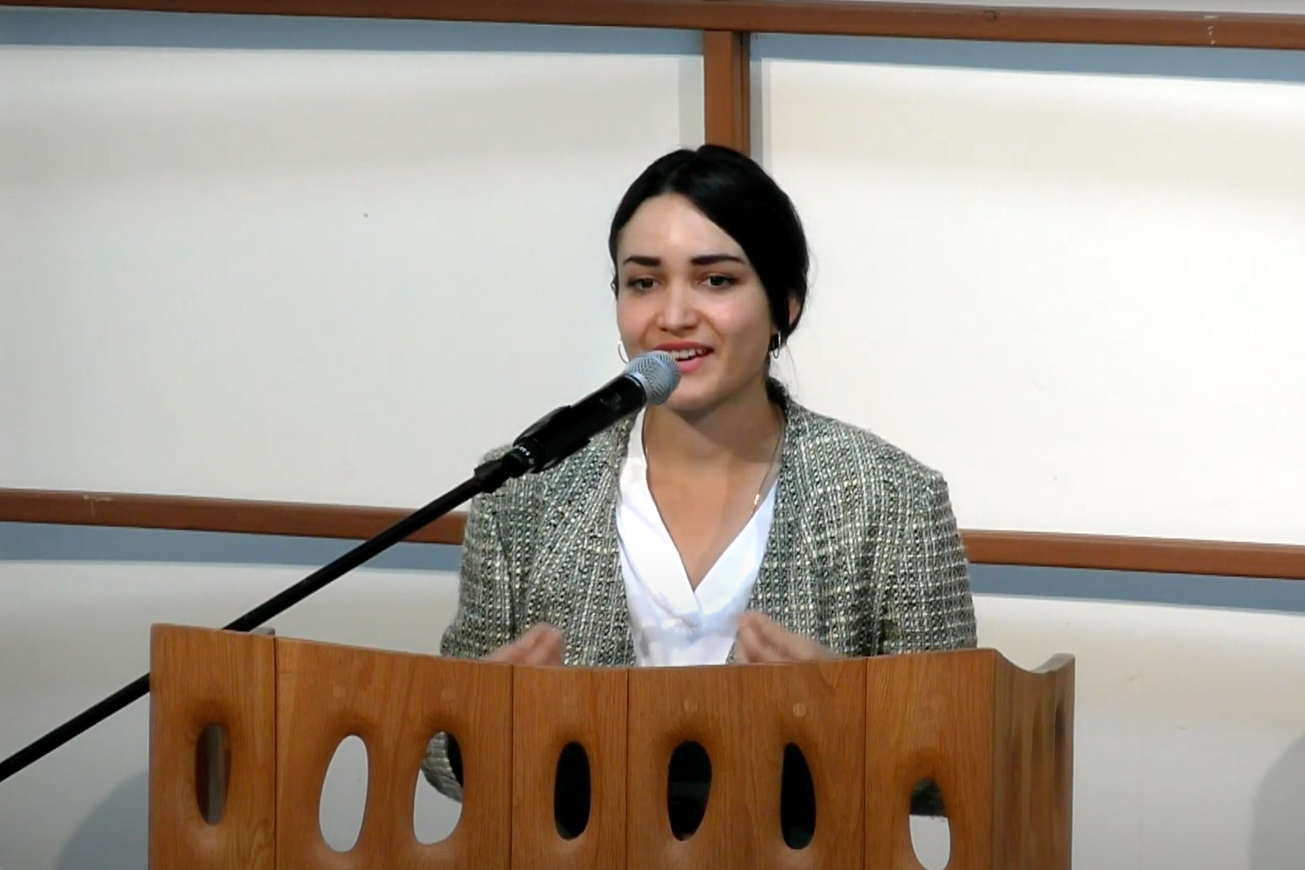 Ilka Vega speaks at podium