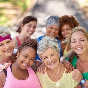 7 women in workout clothes smiling