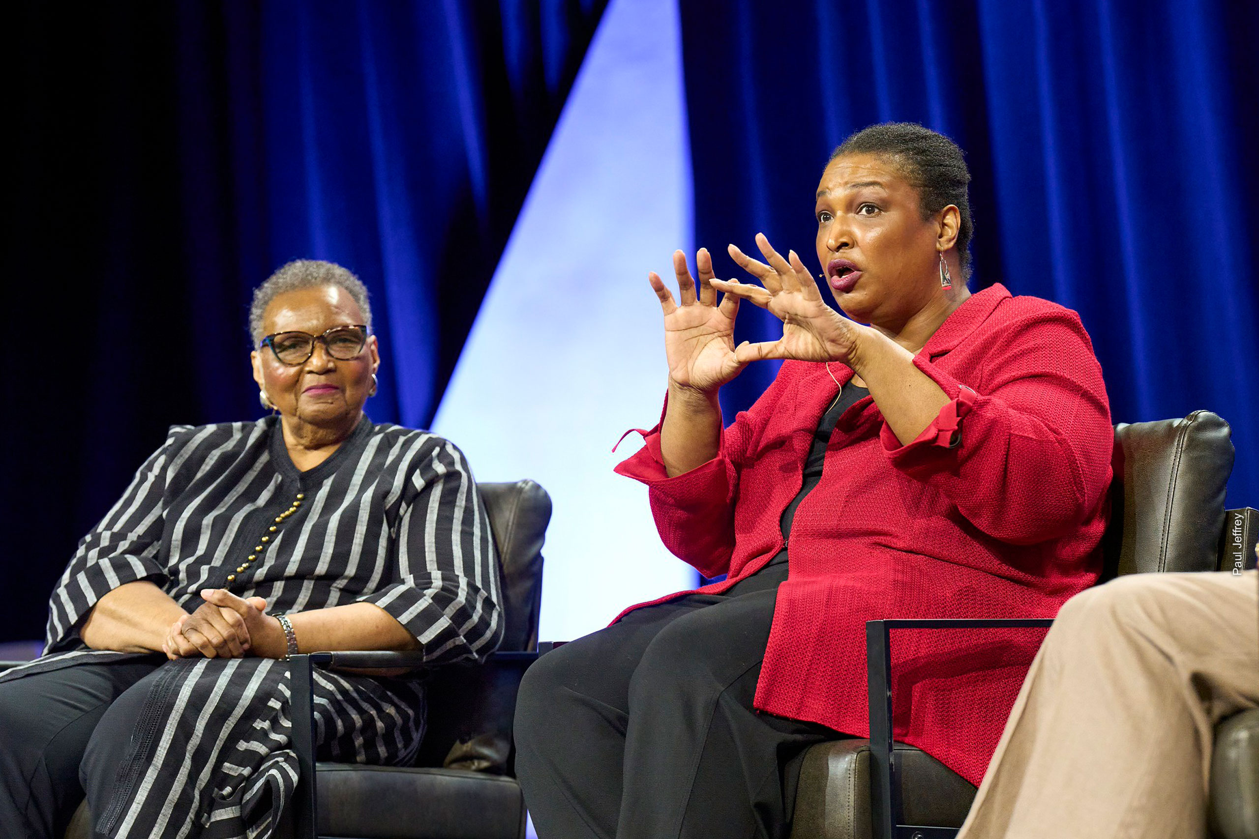 Stacey and Carolyn Abrams seated onstage.