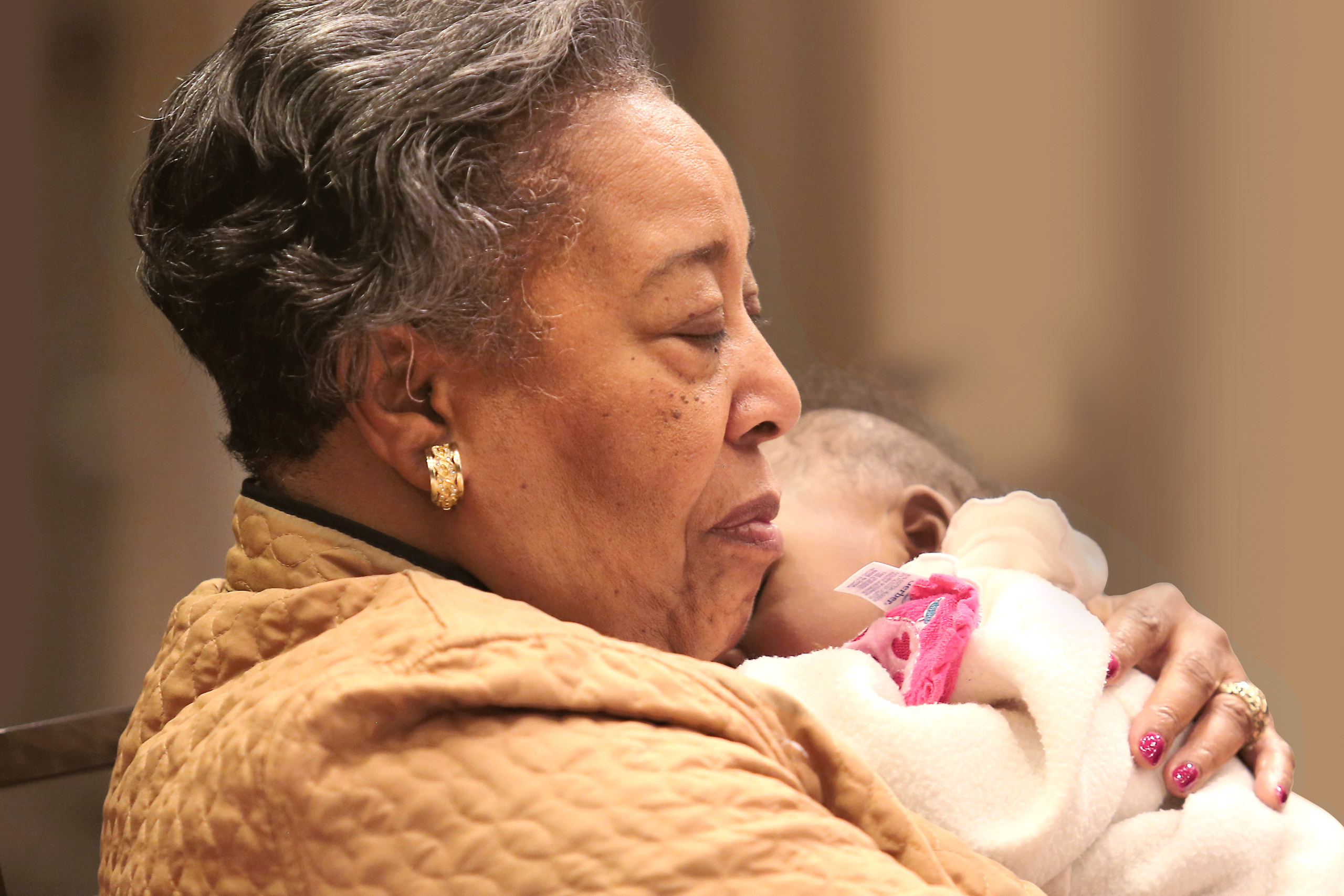 Clara Ester holds a baby